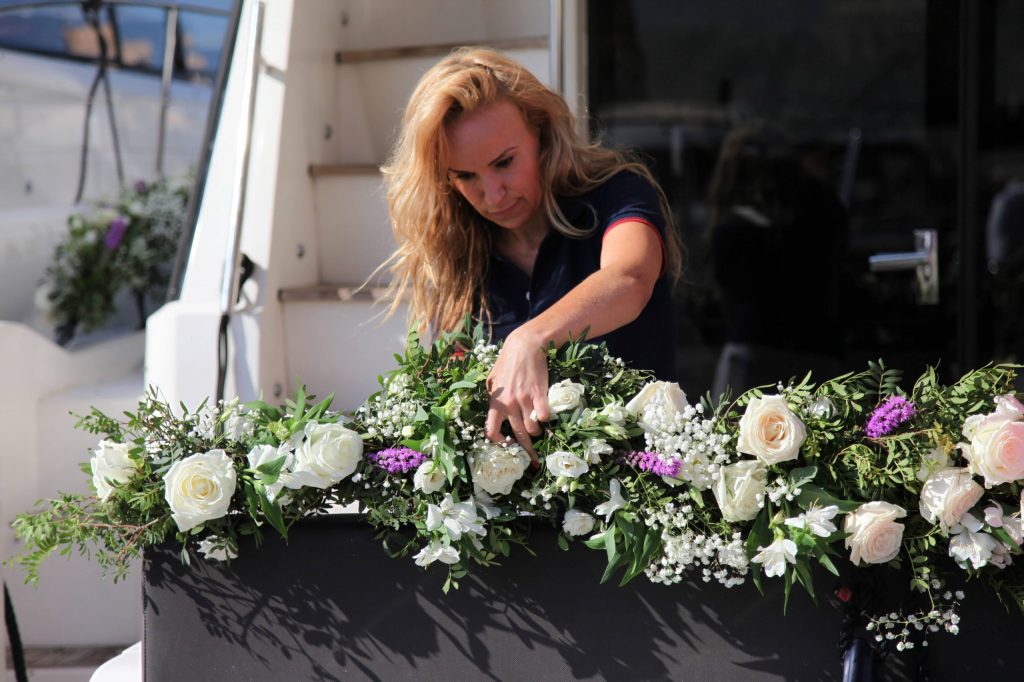 Nemocean team member arranging flowers onboard the yacht